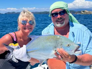 Angler holding a blue trevally inshore in Costa Rica