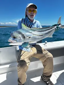 Angler holding a roosterfish on the boat in Costa Rica