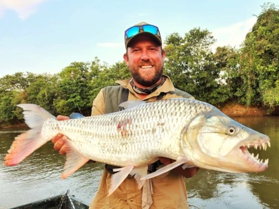 A large tiger fish being held in Tanzania