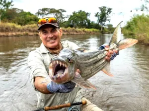 An angler showing tigerfish teeth in Tanzania