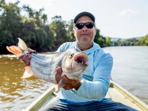 An angler showing tigerfish teeth in Tanzania