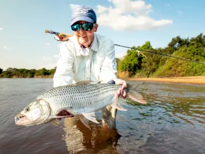 An angler showing a tigerfish caught on fly rod in Tanzania